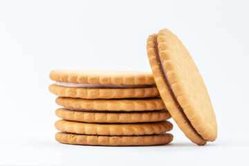 Sandwich cookies lie one on top of the other, isolated on a white background.