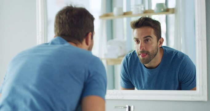 Reflection, man in bathroom washing face and morning routine of cleaning, skincare and self care. Grooming, facial towel and dermatology, male in mirror with water and cloth to clean skin in home.