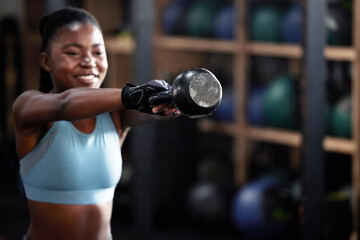 Fitness, kettlebell or happy black woman in training, workout or bodybuilding exercise for grip strength power. Body builder, smile or strong African sports athlete with at gym lifting heavy weights