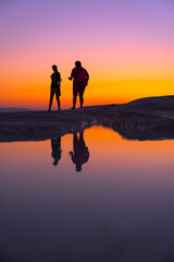 Fototapeta premium People walking by the lake at sunset, silhouette, Pamukkale - Turkey