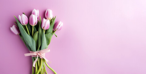 Bouquet of pink tulips on pink background. Flat lay, top view, copy space