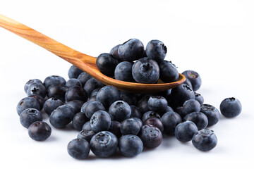 Fresh blueberries in wooden spoon