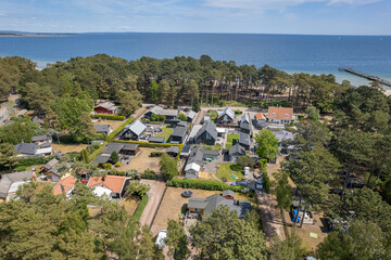 Fototapeta na wymiar Aerial view private houses close to the beach and sea. Beautiful sea, maritime landscape, seascape. Forest near the beach. Resort and recreational area, luxury real estate. 