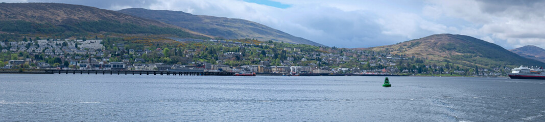 Fototapeta na wymiar The town of Fort William, Glasgow, UK, as seen from the sea (loch)