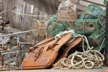A pile of lobster and crab cages stacked on a jetty - Powered by Adobe