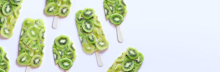Summer background with kiwi slices laid out in the form of ice cream. Kiwi banner, copy space. Ice...