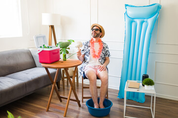 Hispanic man happy and relaxed pretending to be at the beach having staycations