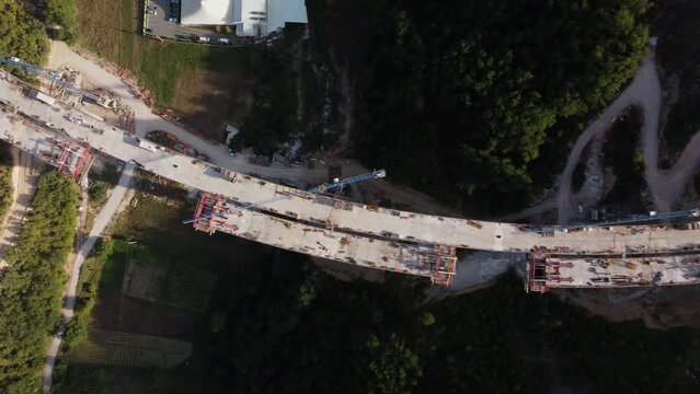 Highway bridge under construction. Aerial view of nes road. Freeway being built on a mountain terrain..