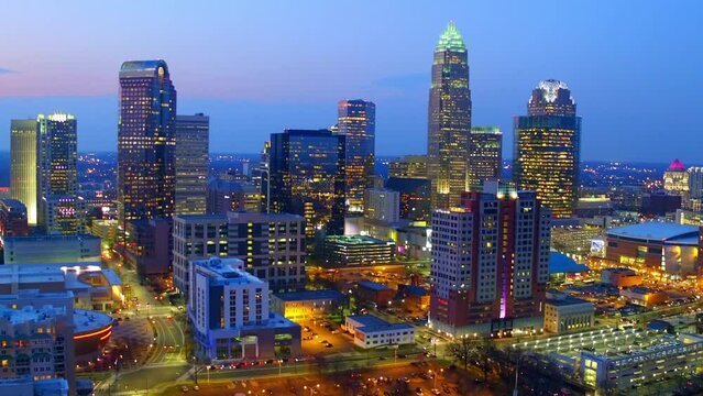 Aerial Shot Of Illuminated Modern Buildings In City Against Sky, Drone Flying Backward Over Cityscape At Dusk - Charlotte, North Carolina