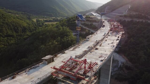 Highway bridge under construction. Aerial view of nes road. Freeway being built on a mountain terrain..