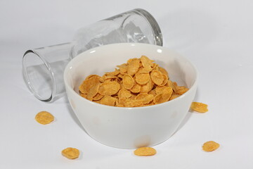 Yellow corn flakes in a white bowl. An illustration in the form of a photo to introduce a food product.