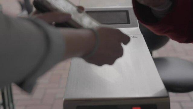 This close up video shows a cell phone ticket barcode being scanned at a ticket entry station in slow motion.