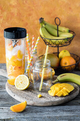 Empty jar mugs waiting for a freshly blended mango citrus smoothie.