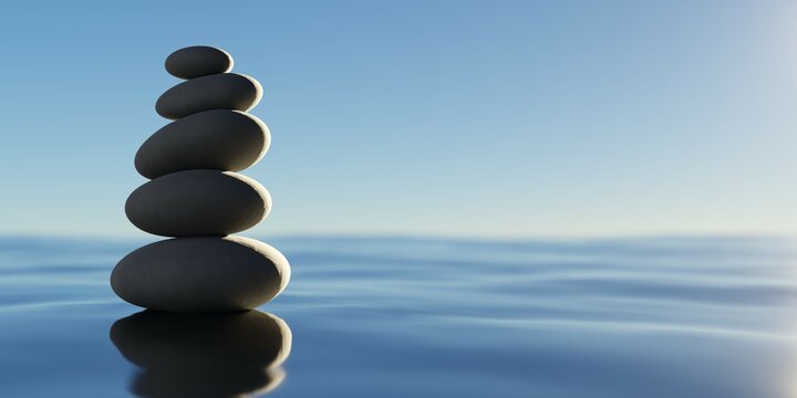 Stack of black pebbles in balance on blue water surface with sky background, zen, spa, yoga or meditation concept