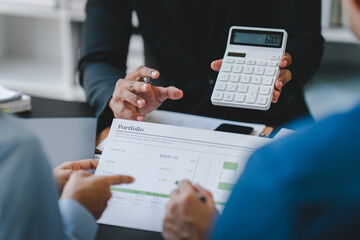 Young colleagues discussing business and charts in office room. Analyze, finance, accounting, tax, marketing, teamwork concept.