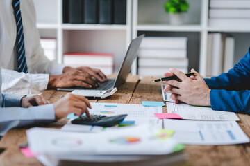 Young colleagues discussing business and charts in office room. Analyze, finance, accounting, tax, marketing, teamwork concept.