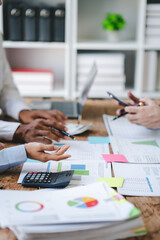 Young colleagues discussing business and charts in office room. Analyze, finance, accounting, tax, marketing, teamwork concept.