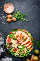 Gourmet salad with fresh figs, grilled chicken, parmesan cheese, grape, arugula, swiss chard with...