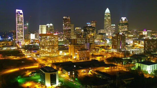 Aerial Shot Of Illuminated Modern Buildings In City At Night, Drone Flying Forward Over Cityscape Against Sky - Charlotte, North Carolina