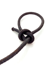 Perspective view of cape with isolated sailor knot. Knot tied in rope on white background. Close up of Loop knot. Navigation and Mooring concept.