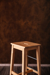 wooden stool on brown background