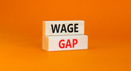 Wage gap symbol. Concept words Wage gap on wooden blocks on a beautiful orange table orange background. Business, support and wage gap concept. Copy space.