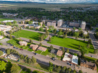 Fototapeta na wymiar Grassy area of University campus with apartment buildings and houses aerial view