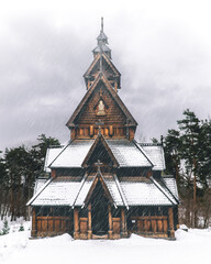 Fototapeta na wymiar Wooden old church in the middle of a snow landscape