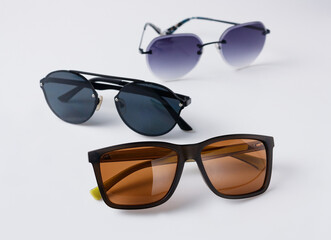 sunglasses with brown, blue, purple lenses on a white background, copy space