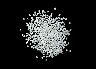 Obraz premium Heaps of uncooked Japanese short grain rice piled together isolated on black background.