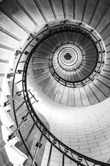 Black and white vertical real photography of Spiral stairs inside the lighthouse