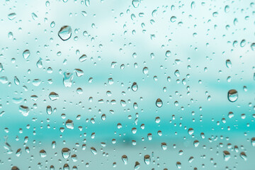 Drops on a window glass with blurry blue background