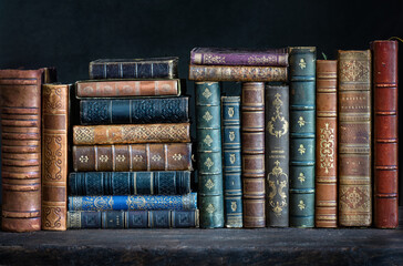 Old books on wooden shelf. Tiled Bookshelf background.  Concept on the theme of history, nostalgia,...