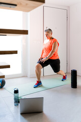 Overweight adult female practicing sports indoors