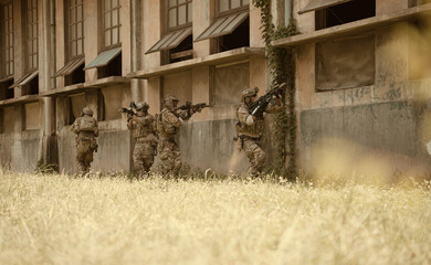 Professional marine soldiers training with weapon on a military range.