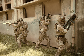 Professional marine soldiers training with weapon on a military range.