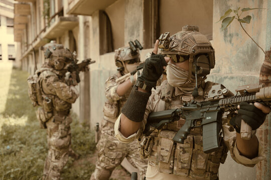 Professional marine soldiers training with weapon on a military range.