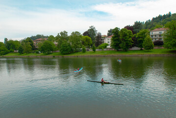 Fototapeta na wymiar Italy, Piedmont, Turin, people go canoeing on the river Po in the Valentino park in front of the Castle of the Valentino