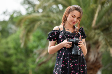 Woman photographer in the dress holding camera