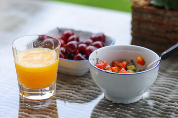 Healthy food for breakfast in the summer garden. Salat with tomato and parsley. 