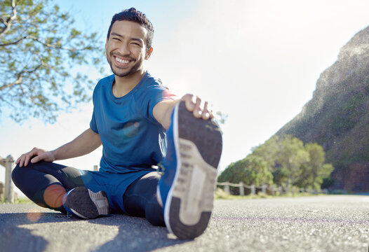 Exercise, Portrait And Stretching With A Man Runner Outdoor In The Mountains For A Cardio Or Endurance Workout. Fitness, Sports And Smile With A Young Male Athlete Getting Ready For A Run In Nature