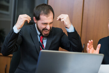 Angry businessman yelling in his office
