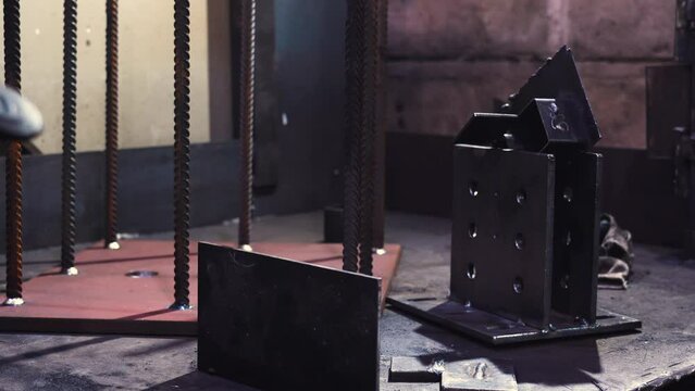 "Metal parts on welding station (welder's workplace), gloomy atmosphere, old building"