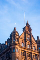 Fototapeta na wymiar Buildings in Edinburgh at Dusk, with the moon. 