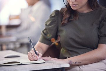 Hands, call center and woman writing in notebook, planning and schedule in office. Telemarketing, book and business person taking notes for reminder, sales list and information for customer service.