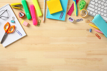 Back to school concept. Colorful school items on wooden desk table. Flat lay, top view, overhead.