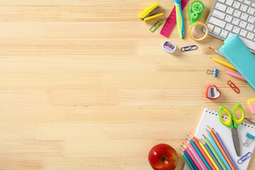 Back to school concept. Frame of colorful school supplies on wooden desk table. Flat lay, top view.