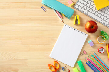 Blank notepad with school supplies on wooden table. Back to school concept