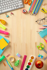 Frame of school supplies on wooden desk table. Back to school, education concept