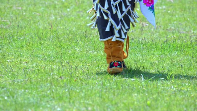 Pow Wow, 2nd Annual Two Spirit Powwow, by 2-Spirited People of the 1st Nations. Women traditional dance in Jingle Dress a shoes healing or medicine dress.